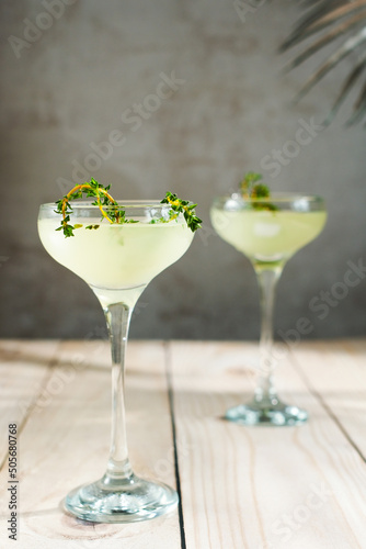 Daiquiri cocktails decorated thyme sprigs.