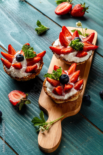 Fruit dessert tarts with cream, strawberry and blueberry. banner menu recipe place for text