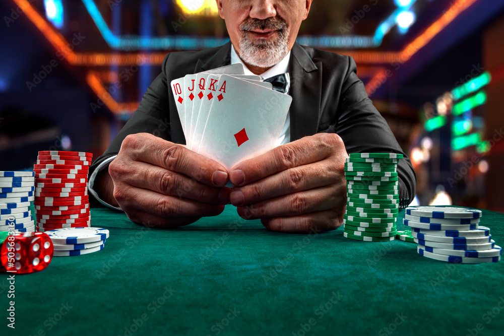 Gambling concept. Close up of Poker Player male hand Winning Royal Flush at  casino, gambling club. Сasino chips or Casino tokens, dice, poker cards,  gambling man lucky guy, games of chance Photos |