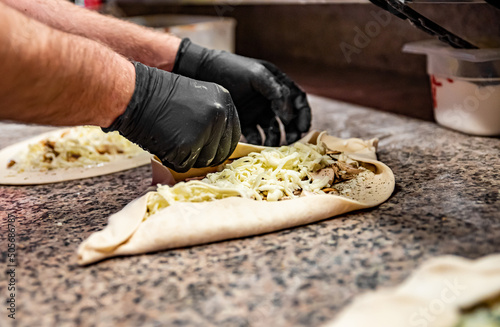 chef hand cookind pide on kitchen table  photo