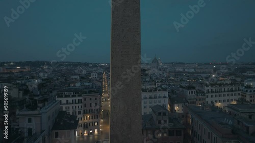 Aerial view closely around the Obelisco Sallustiano revealing the Spanish steps, night in Rome, Italy - circling, drone shot photo