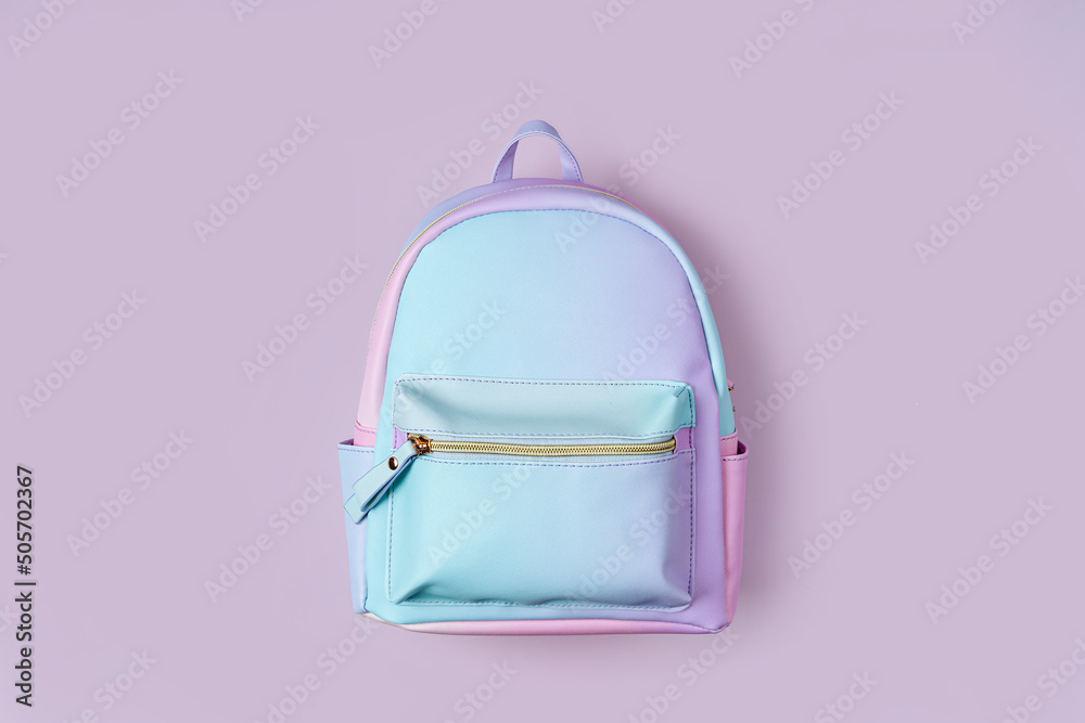 School backpack in pastel color on pink background. Concept back to school. - obrazy, fototapety, plakaty 
