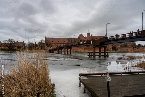 A bridge over the Nogat River in Malbork, Poland. This medieval Castle of the Teutonic Order is the largest castle in the world measured by land area and a UNESCO World Heritage Site photo