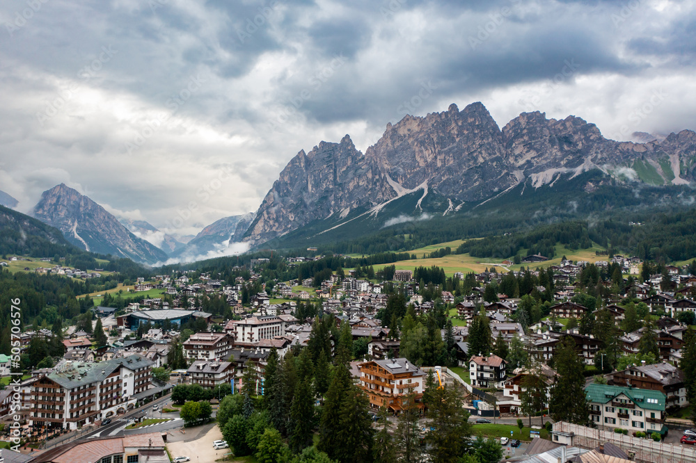 Panorama drone view of the town of Cortina d'Ampezzo in the mountains in the Dolomites in Italy. View from a drone on a city in the mountains of the Alps in the fog
