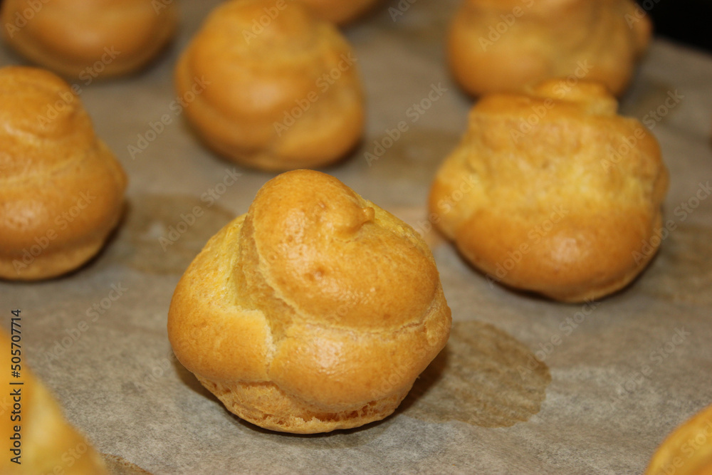 pan of golden cream puffs, perfectly cooked, closeup