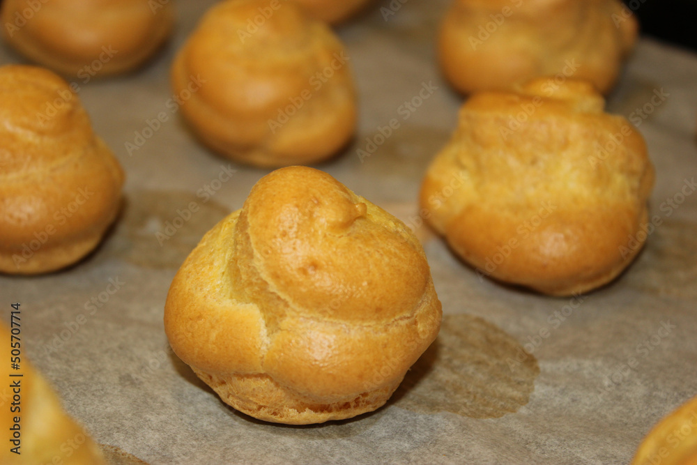 pan of golden cream puffs, perfectly cooked, closeup pan of golden cream puffs, perfectly cooked, closeup