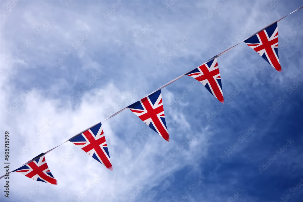 UK Union jack bunting flags in blue sky celebrating british culture
 - obrazy, fototapety, plakaty 