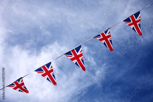 UK Union jack bunting flags in blue sky celebrating british culture
 photo