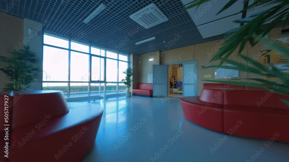 Motion through foyer with metal tourniquets to open door of gym at contemporary sports school drone first point view