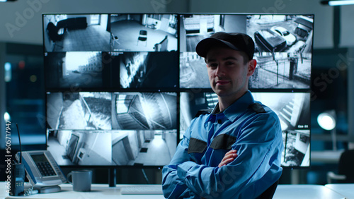 Canvas Print Portrait of security guard looking at camera with cctv cameras multiscreen on ba