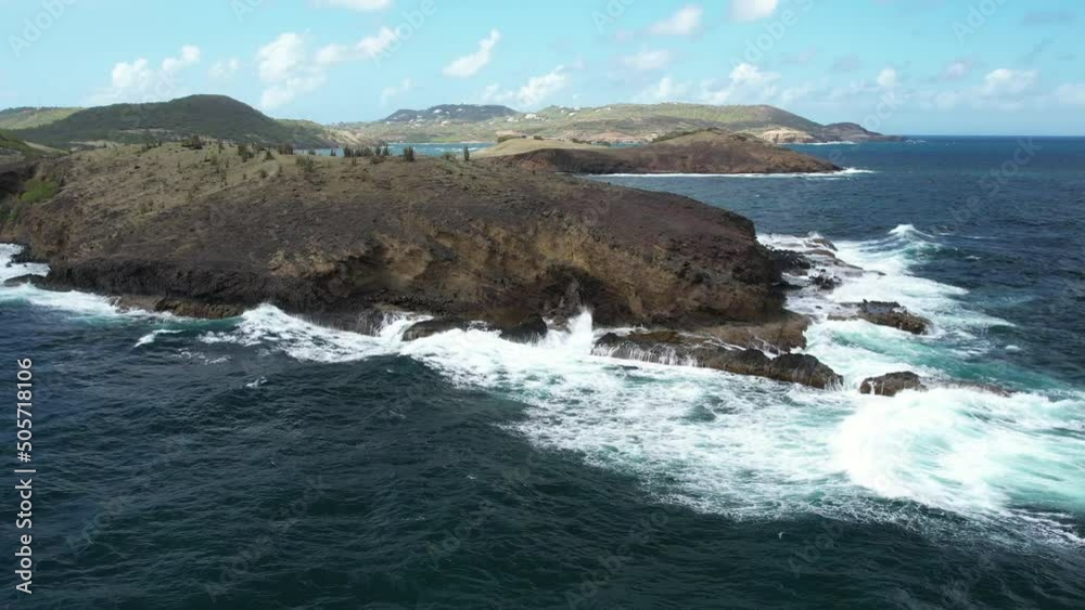 Spray from blowhole with waves crashing around. Aerial shot of St.Lucia's East coast. Spray from blowhole with waves crashing around. Aerial shot of St.Lucia's East coast.