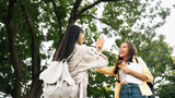 Two beautiful young Asian college students are greeting each other by slapping their hands. With a smiling face in casual attire in the park.
happiness, love, friendship of friends,happiness concept.