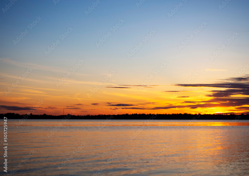 Colorful backdrop. Sea landscape. Blue sky. Sunset on the river.