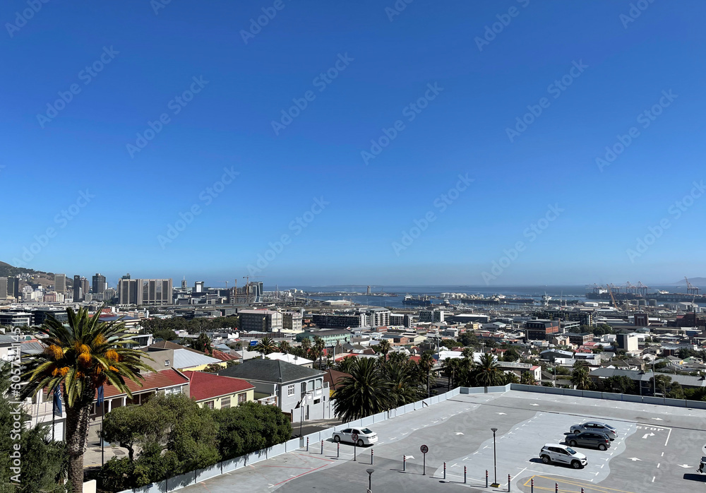 Cape Town, South Africa. 2022. Wide view looking towards the city centre, harbour and industrial area of Cape Town against a blue sky.