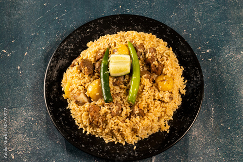 Spicy Beef Pulao in a dish isolated on marble background top view of beef biryani Pakistani and Indian food photo