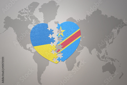 puzzle heart with the national flag of ukraine and democratic republic of the congo on a world map background. Concept.