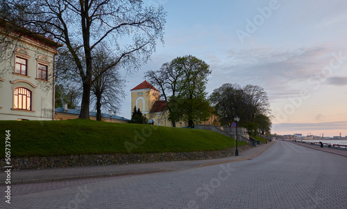 An old castle at sunset, tower close-up. Ventspils, Latvia. Travel destinations, landmarks, sightseeing, culture and religion, history, past, architecture themes photo