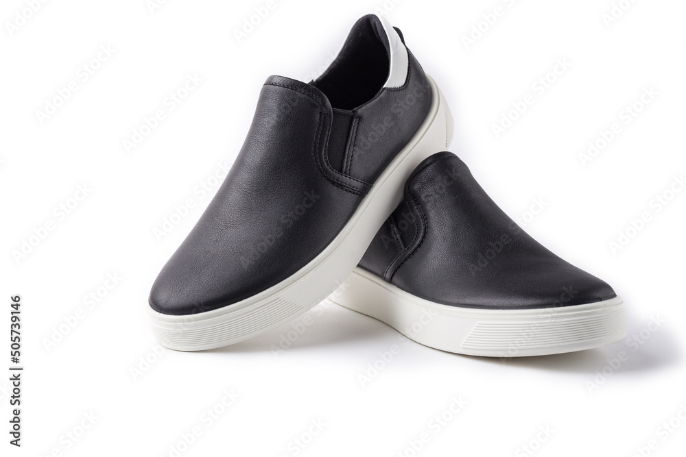 Pair of black leather slip-ons shoes on white background with copy space. Pair of black leather slip-ons shoes on white background with copy space.