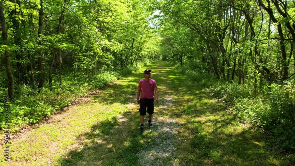 Asian Man Enjoying Summer In The Nature. 4k Drone Footage In Green Forest. Asian Man Enjoying Summer In The Nature. 4k Drone Footage In Green Forest.