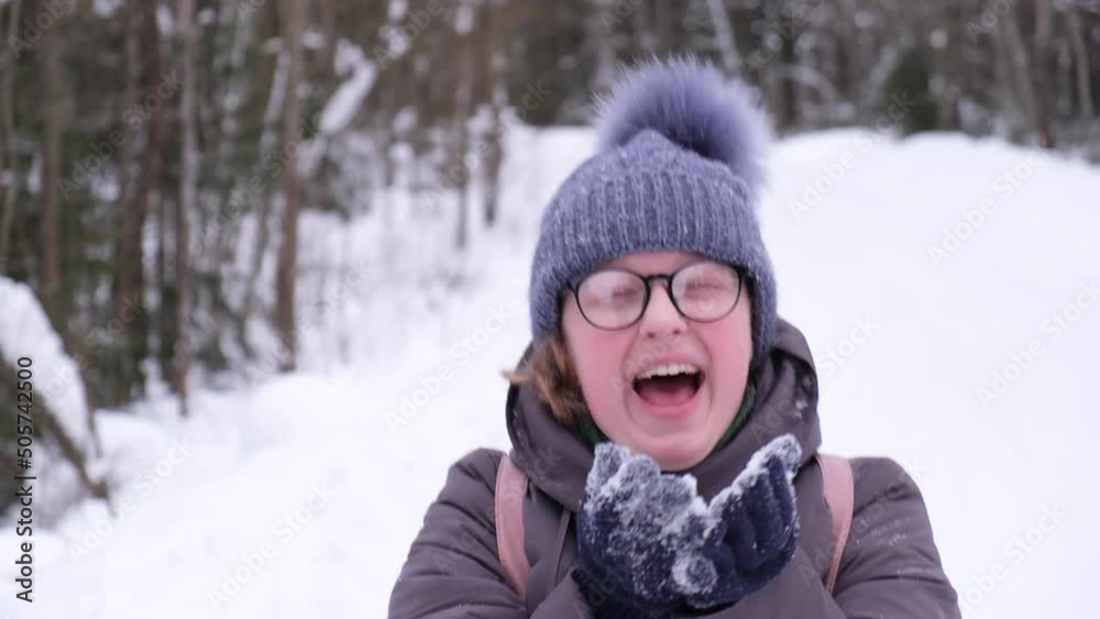 cheerful young woman in glasses and winter clothes outdoors, evening on snake forest road cheerful young woman in glasses and winter clothes outdoors, evening on snake forest road