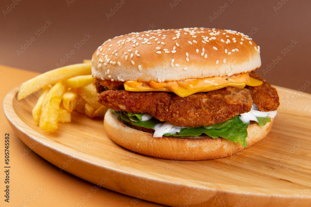 Classic chicken burger on a brown background.