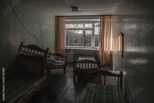 Empty room in an abandoned building. Soviet architecture. Light in the window. Beautiful shadows. Atmospheric photo of an abandoned building.