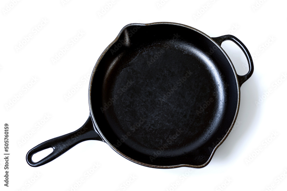 Closeup top view rough surface used skillet cast iron pan isolated on white background. Closeup top view rough surface used skillet cast iron pan isolated on white background.