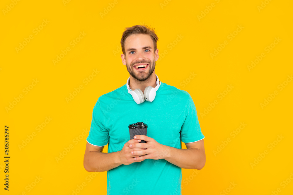 happy man in modern earphones with coffee cup. online education. back to school. happy man in modern earphones with coffee cup. online education. back to school.