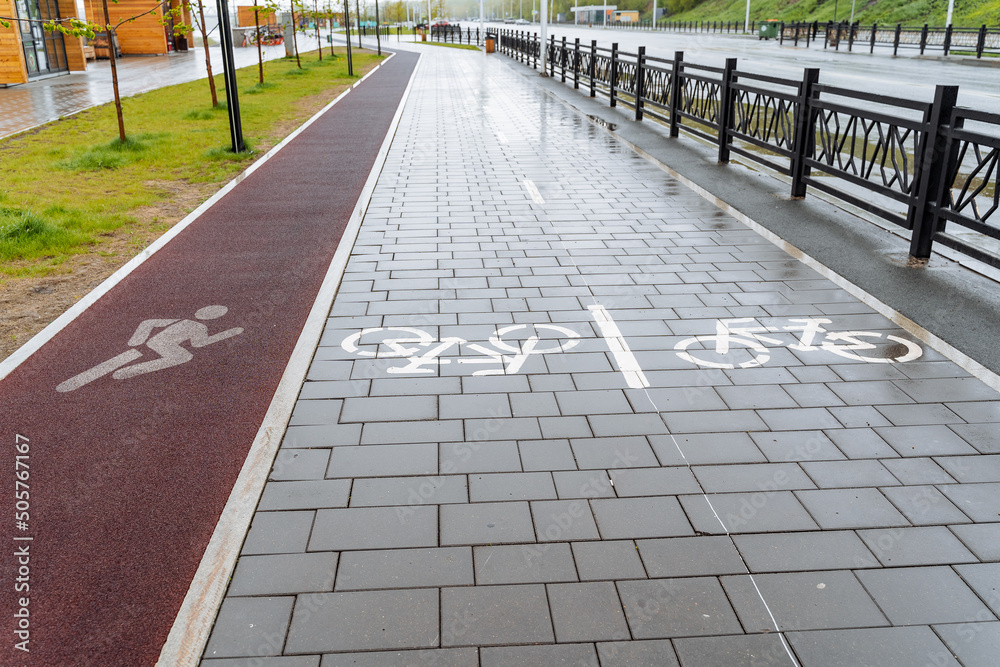 City park pavement markings bike path, treadmill on asphalt, red carpet for jogging, place for cycling, road sign