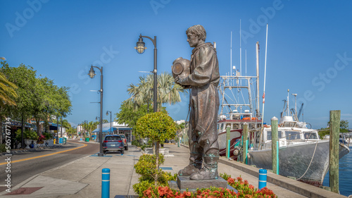 Tarpon Springs sponge docks with boats and diver statue in this greek inspired small town in Florida