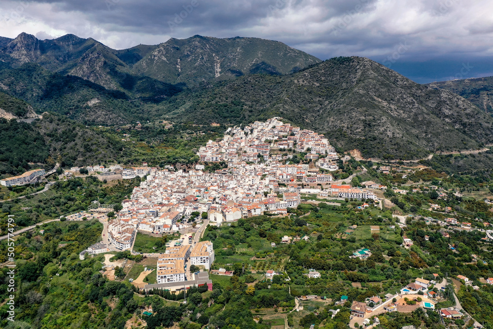 Aerial perspective of Ojen village, small white Andalusian town located in the mountains, in the heart of the Costa del Sol, not far from Marbella. In background beautiful mountains of Sierra Blanca 