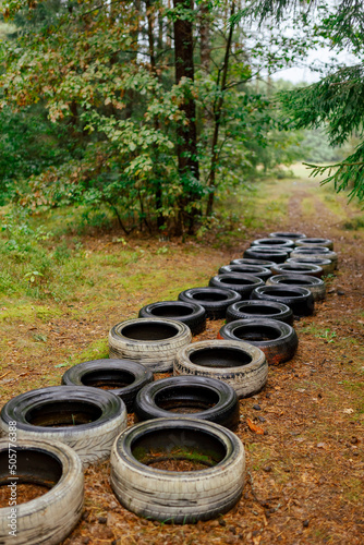 tires on the ground in the forest. an empty obstacle course in the forest © kos159