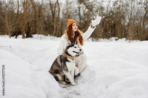 Fototapeta Naklejka Na Ścianę i Meble -  woman with a purebred dog outdoor games snow fun travel fresh air