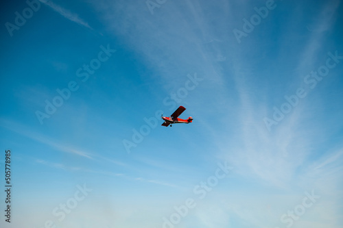 Red plane against the sky.