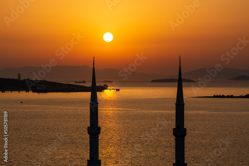 minaret on sunset and sea © Aytug Bayer