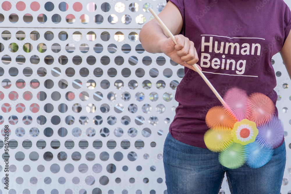 woman with rainbow pinwheel and purple human being t-shirt woman with rainbow pinwheel and purple human being t-shirt