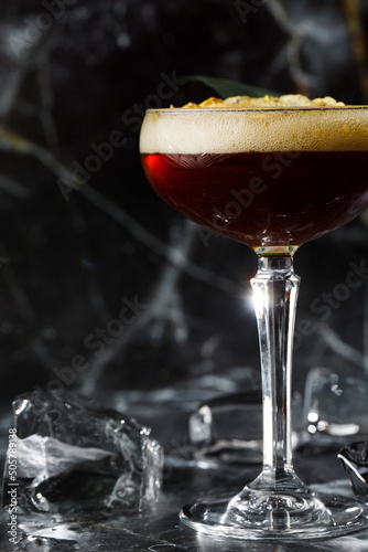 White russian cocktail, trendy alcoholic drink with vodka, coffee liqueur, cream and ice on black marble background