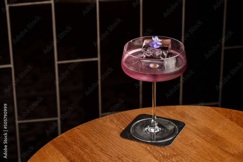 Aviation, drink with gin, lemon juice,maraschino liqueur and violet cream liqueur standing on bar counter