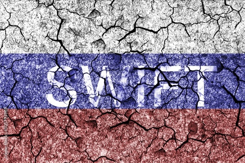 Flag of Russia painted on a cracks wall with word SWIFT