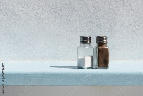 Salt and pepper aginst white background photo