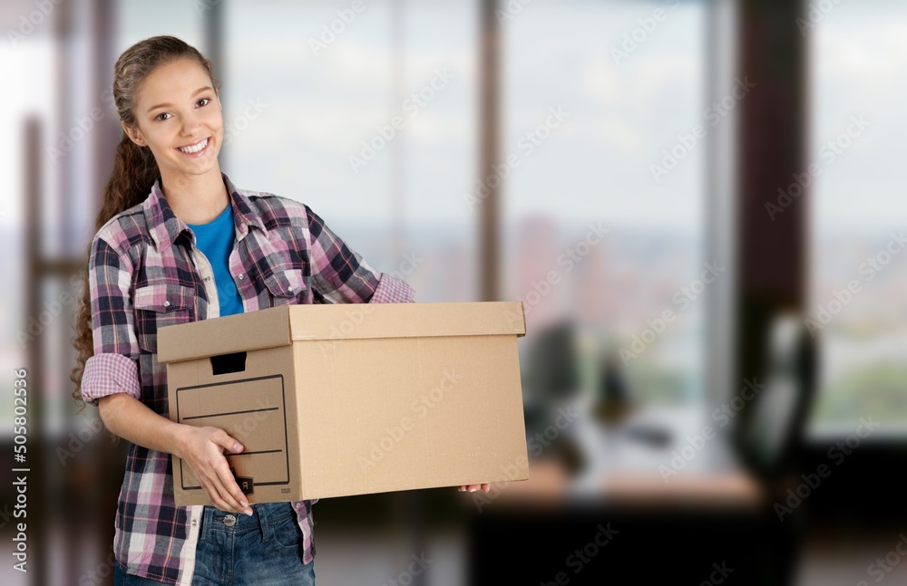 Delivery package concept. Smiling young woman standing at her front door receiving a package from a courier. Delivery package concept. Smiling young woman standing at her front door receiving a package from a courier.