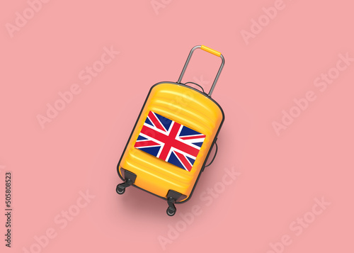 Orange color travel luggage and English flag. On pink coral color background. Horizontal composition. The background is an endless backdrop. Isolated with clipping path.