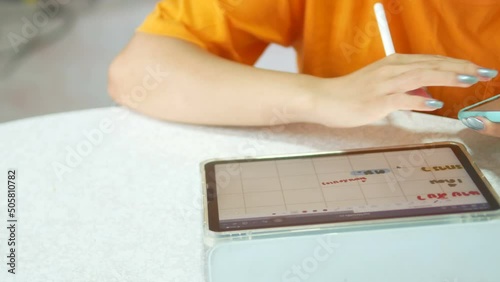 closeup woman use tablet with digitizer pen and smartphone for work in home office.