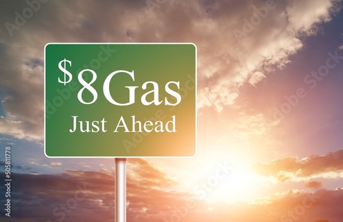 $8 Gas Green letter on Road Sign Against Cloudy Sky.