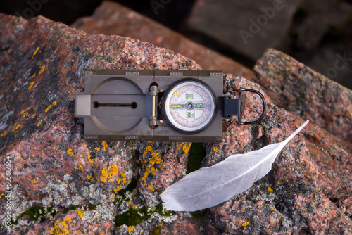 compass and pen on the rock