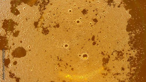 Macro shot of beer bubbles, abstract background, texture beer or oil, or honey