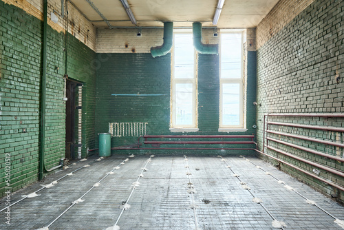 Old abandoned brick building with green walls