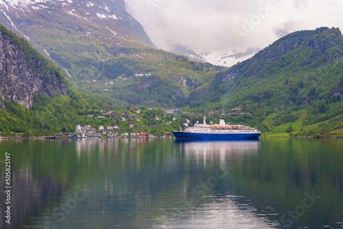Beautiful view at a the norwegian village Geiranger with a cruise ship