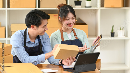 Two business partner preparing parcel boxes of product for delivery to customers. E-commerce, Online selling concept