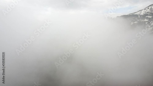 The drone rises from under the clouds and its gaze overlooks the peaks of Bukreyev and Furmanov photo